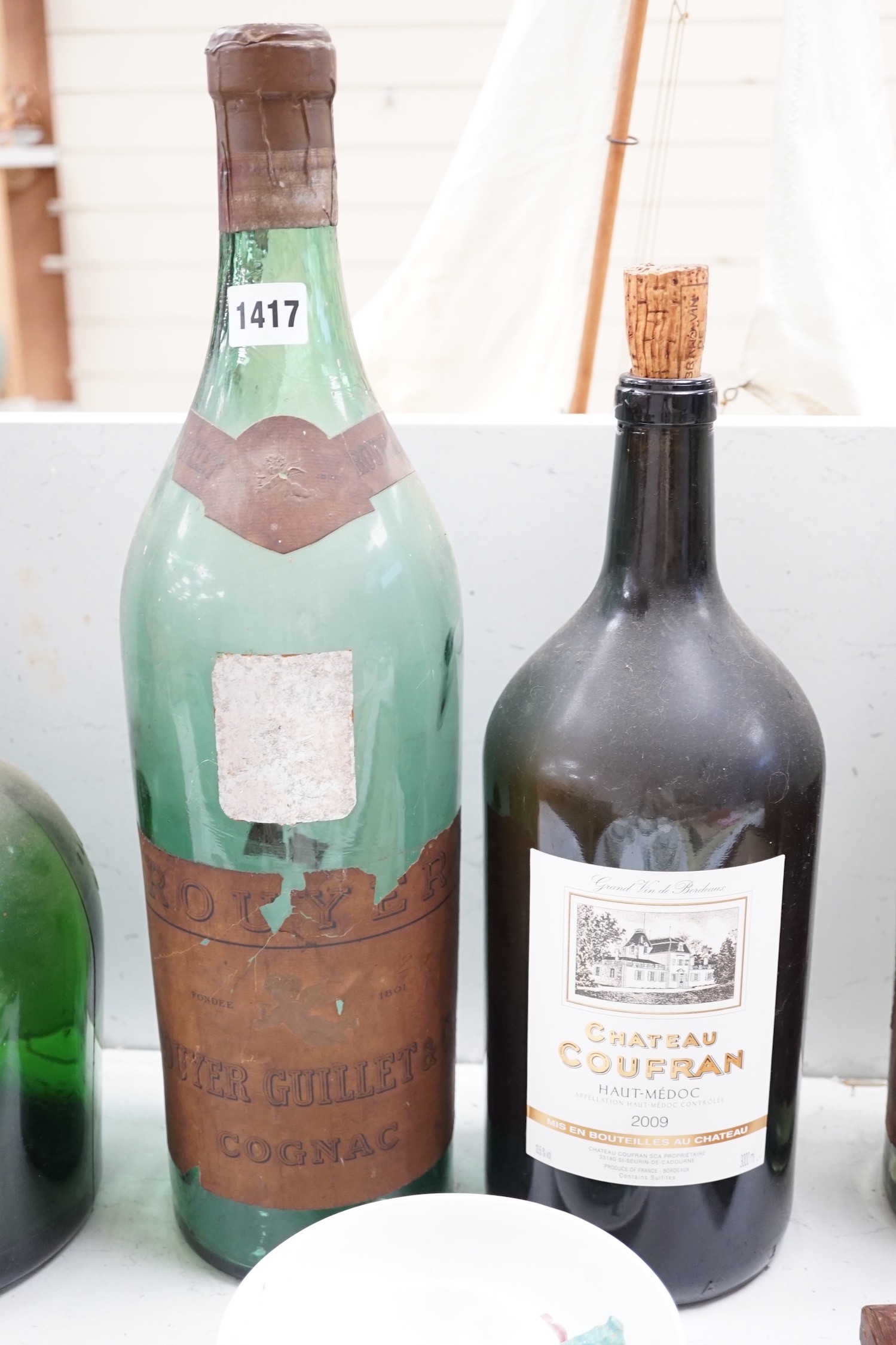 A collection of oversize and advertising bottles for Cinzano, Courvoisier, Moet Chandon, Rouyer Guillet cognac, Grand Opera cognac and Chateau Coufran, largest 52 cm